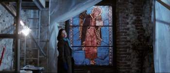 The Mayor standing beside a stained glass window - In the Beginning